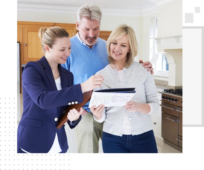 Real estate agent showing a couple a property document.